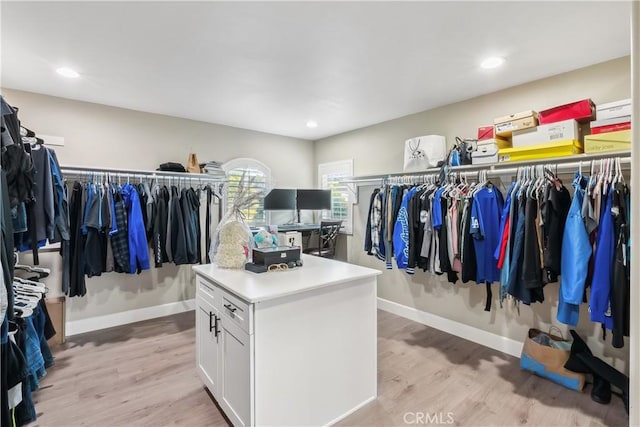 walk in closet with light wood-type flooring