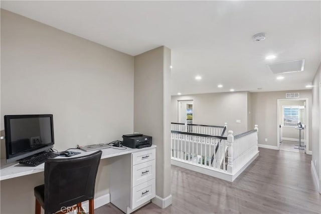 office space featuring light wood-style flooring, visible vents, recessed lighting, attic access, and baseboards