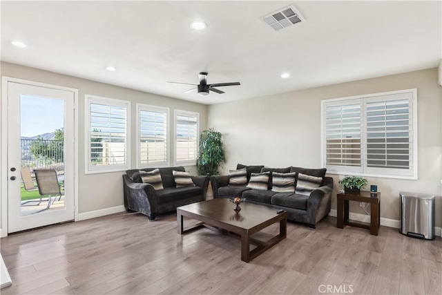 living room with plenty of natural light, visible vents, and light wood-style flooring