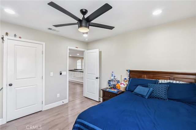 bedroom featuring visible vents, baseboards, a ceiling fan, light wood-style floors, and recessed lighting