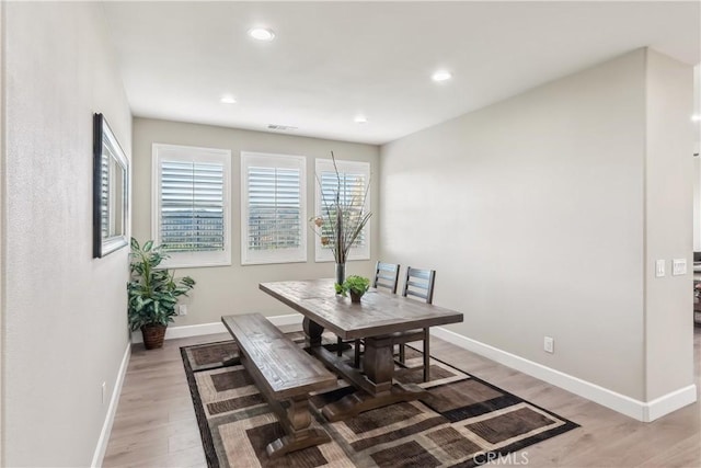 dining space with recessed lighting, light wood-style flooring, baseboards, and visible vents