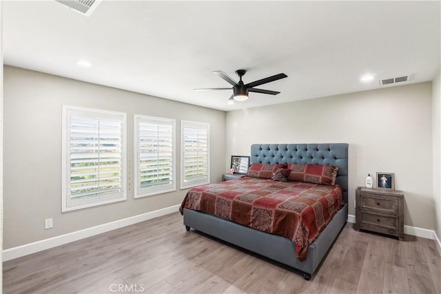 bedroom featuring visible vents, baseboards, and wood finished floors