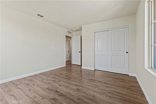 11102 Duran, Jurupa Valley, CA 91752 - unfurnished bedroom with wood finished floors, baseboards, and visible vents
