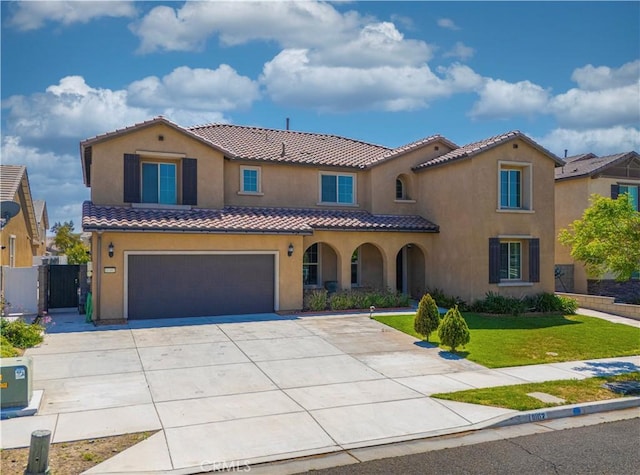 11102 Duran, Jurupa Valley, CA 91752 - mediterranean / spanish house featuring a tiled roof, a garage, stucco siding, a front lawn, and driveway