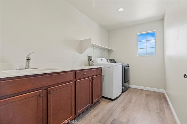 11102 Duran, Jurupa Valley, CA 91752 - washroom featuring a sink, washer and dryer, light wood finished floors, baseboards, and cabinet space
