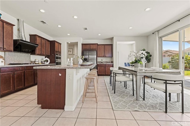 11102 Duran, Jurupa Valley, CA 91752 - kitchen with backsplash, light tile patterned flooring, extractor fan, visible vents, and appliances with stainless steel finishes
