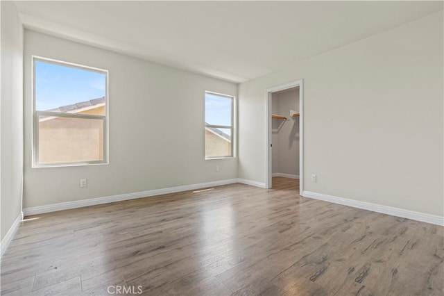 11102 Duran, Jurupa Valley, CA 91752 - unfurnished bedroom with baseboards, multiple windows, and wood finished floors