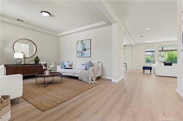 11102 Duran, Jurupa Valley, CA 91752 - living room featuring baseboards, recessed lighting, visible vents, a tray ceiling, and light wood finished floors