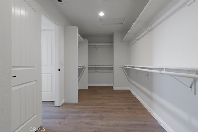 11102 Duran, Jurupa Valley, CA 91752 - walk in closet with visible vents, attic access, and wood finished floors