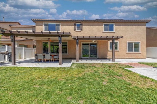 11102 Duran, Jurupa Valley, CA 91752 - back of house featuring a patio, stucco siding, ceiling fan, fence, and a lawn