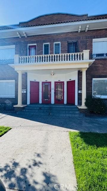 324 W 9th St, Long Beach, CA 90813 - view of front of property with a balcony, a porch, and asphalt driveway