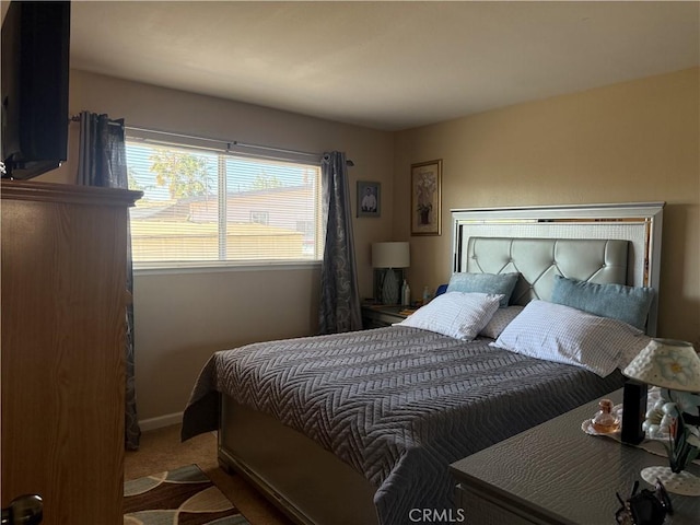 bedroom with baseboards and carpet floors