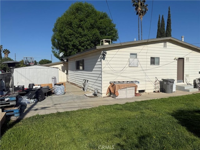 back of property featuring a yard and a patio