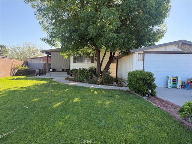exterior space featuring an attached garage, driveway, and fence