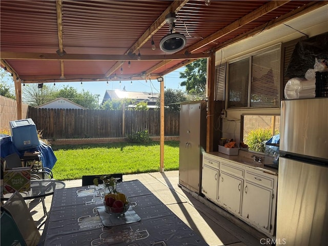 view of patio / terrace featuring a fenced backyard and an outdoor kitchen