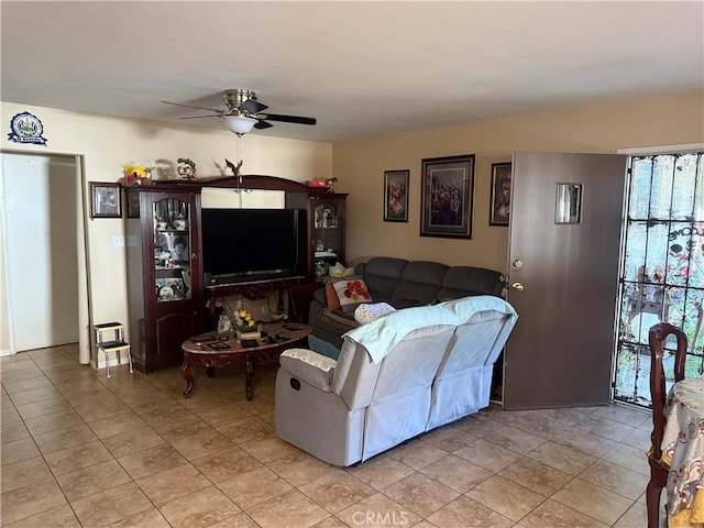 living area featuring light tile patterned floors and ceiling fan