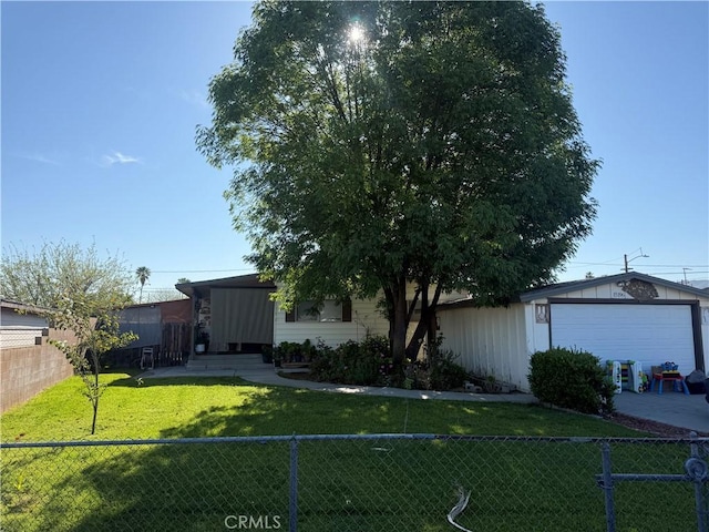 view of front of home featuring a garage, fence, and a front lawn
