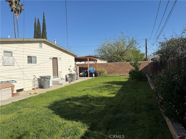 view of yard featuring a patio area and a fenced backyard