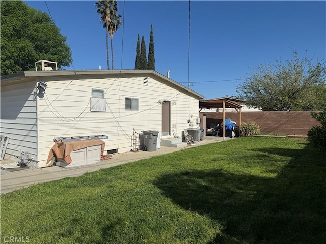 back of property with cooling unit, a yard, a fenced backyard, and a patio area