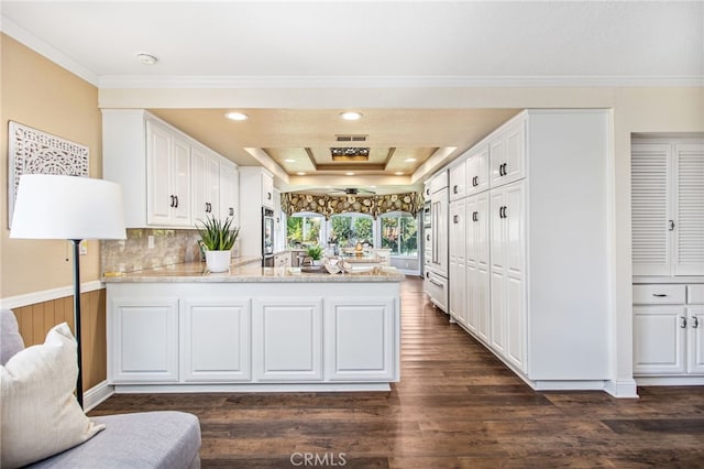 22316 Bear Creek Dr S, Murrieta, CA 92562 - kitchen with a peninsula, white cabinetry, crown molding, light countertops, and a raised ceiling