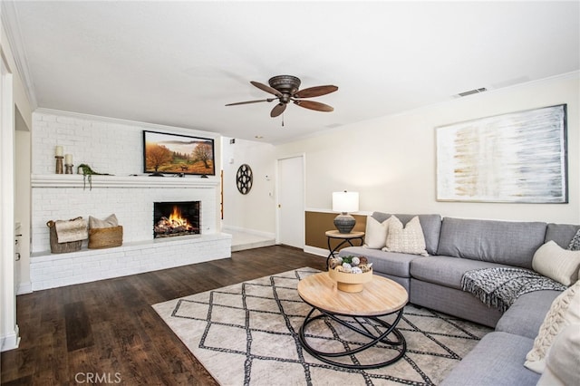 22316 Bear Creek Dr S, Murrieta, CA 92562 - living area featuring visible vents, baseboards, a brick fireplace, wood finished floors, and ceiling fan