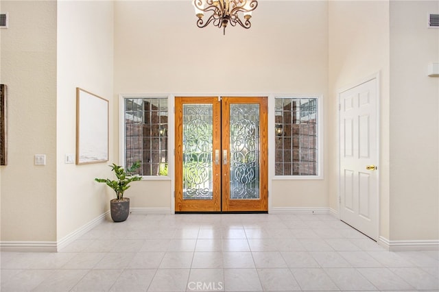 22316 Bear Creek Dr S, Murrieta, CA 92562 - entrance foyer featuring tile patterned floors, french doors, baseboards, an inviting chandelier, and a high ceiling