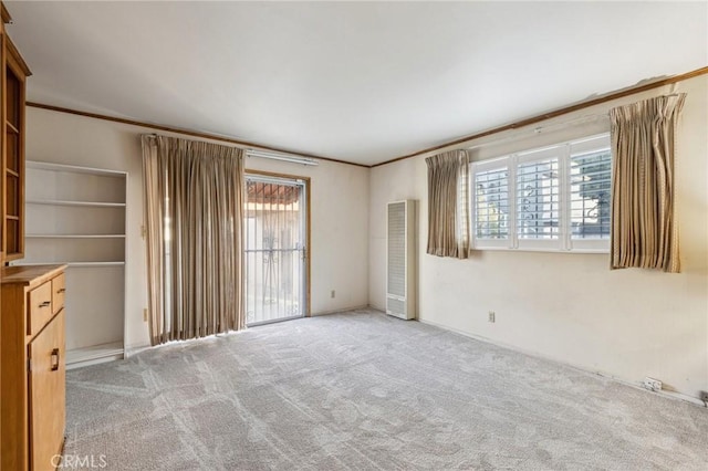 interior space featuring light colored carpet and ornamental molding