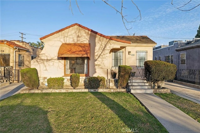 view of front of home featuring stucco siding and a front lawn
