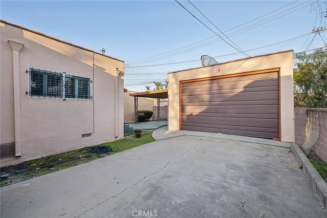 detached garage featuring fence