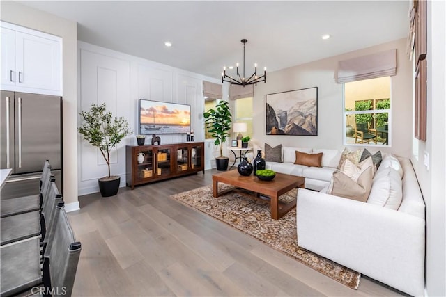 105 Great Park Blvd, Irvine, CA 92618 - living room featuring wood finished floors, an inviting chandelier, and recessed lighting