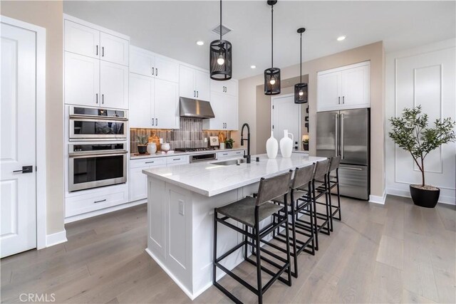 105 Great Park Blvd, Irvine, CA 92618 - kitchen with visible vents, a sink, appliances with stainless steel finishes, under cabinet range hood, and backsplash