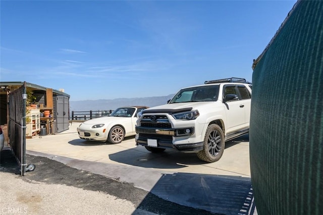 uncovered parking lot featuring a mountain view