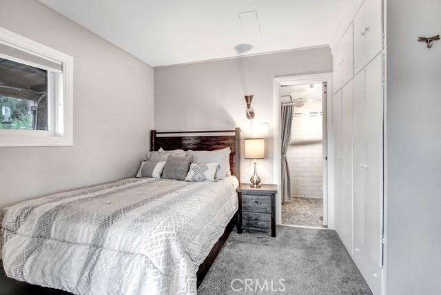 bedroom featuring carpet flooring and ensuite bathroom