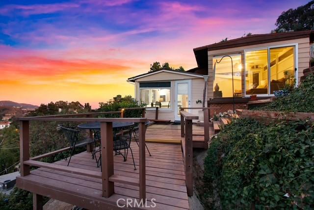 back of house with outdoor dining space and a wooden deck