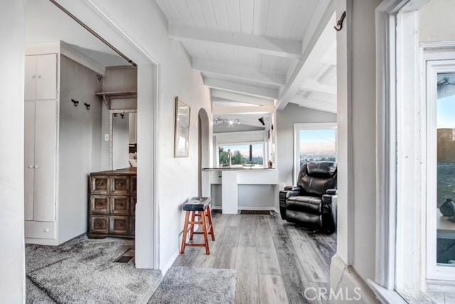 corridor featuring vaulted ceiling with beams and wood finished floors