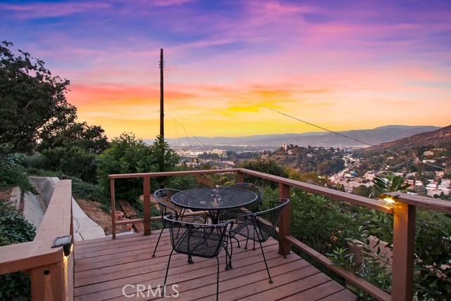 deck with outdoor dining space and a mountain view