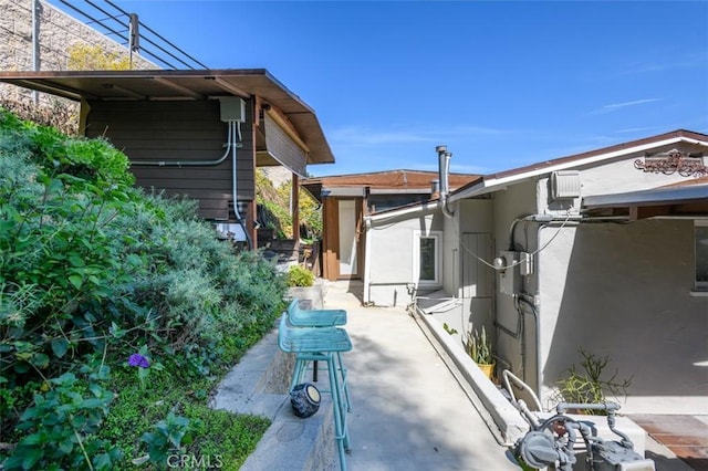 view of property exterior with a patio and stucco siding