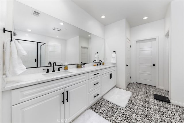 16015 Almond Ave, Chino, CA 91708 - bathroom with a shower stall, a sink, double vanity, visible vents, and baseboards