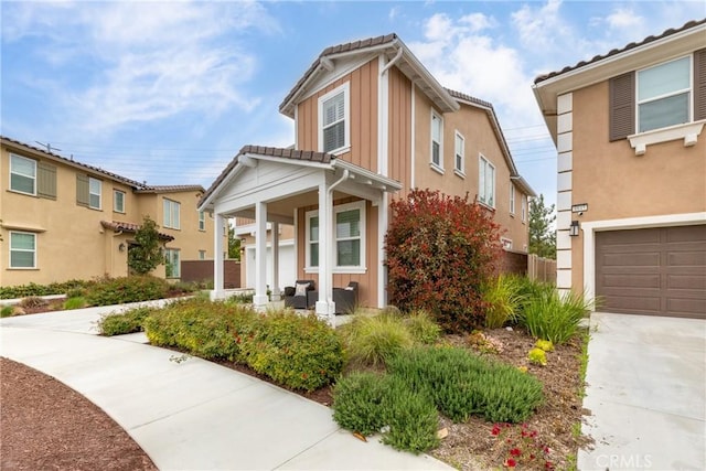 16015 Almond Ave, Chino, CA 91708 - traditional-style house featuring covered porch, concrete driveway, a tile roof, and a garage