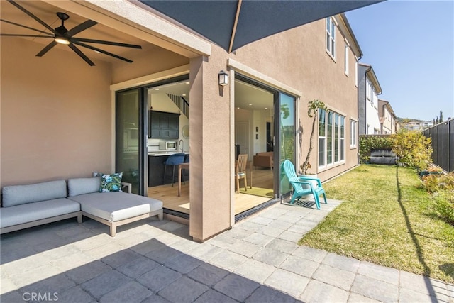 view of patio / terrace with a fenced backyard, an outdoor living space, and ceiling fan