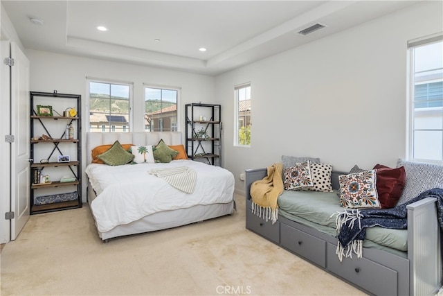 bedroom with visible vents, recessed lighting, carpet flooring, and a tray ceiling