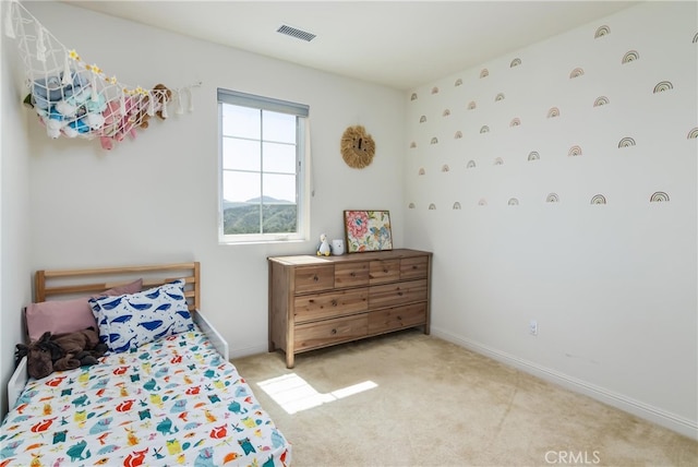 carpeted bedroom featuring baseboards and visible vents