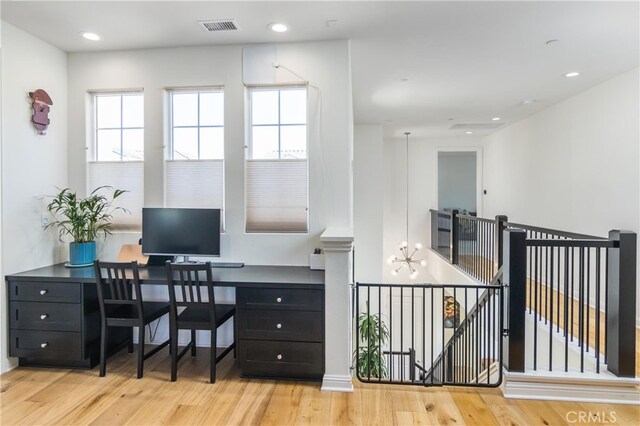 office area with visible vents, wood finished floors, recessed lighting, and a notable chandelier