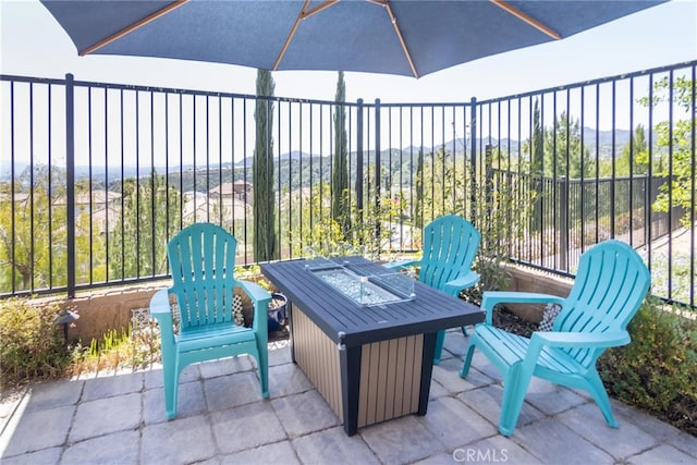 view of patio featuring a fire pit and fence