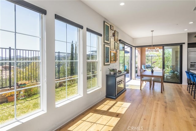 dining space featuring recessed lighting, baseboards, a notable chandelier, and light wood-type flooring