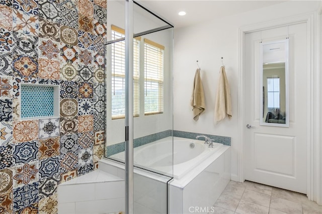 full bathroom with a bath, a shower stall, and tile patterned flooring