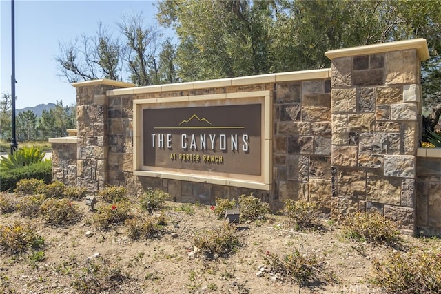 community sign with a mountain view
