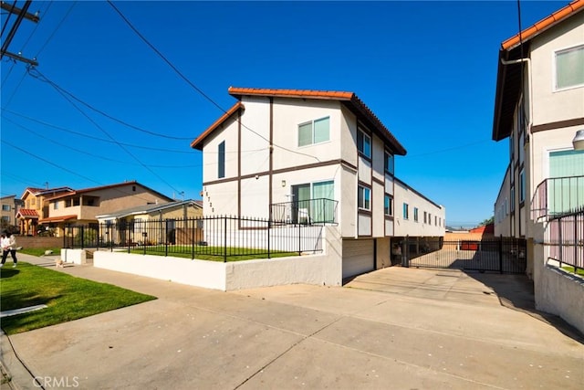 16720 S Dalton Ave, Gardena, CA 90247 - view of home's exterior featuring an attached garage, concrete driveway, a tile roof, fence, and stucco siding