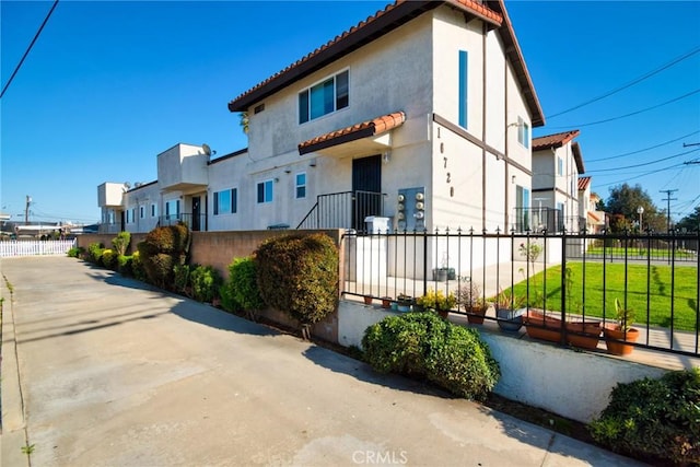 16720 S Dalton Ave, Gardena, CA 90247 - view of front of property with a fenced front yard, stucco siding, and a tile roof