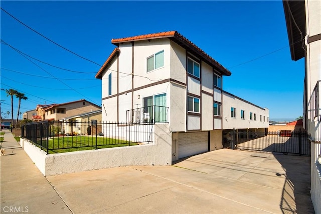 16720 S Dalton Ave, Gardena, CA 90247 - view of property exterior featuring a garage, stucco siding, and fence